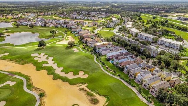 bird's eye view with golf course view, a water view, and a residential view