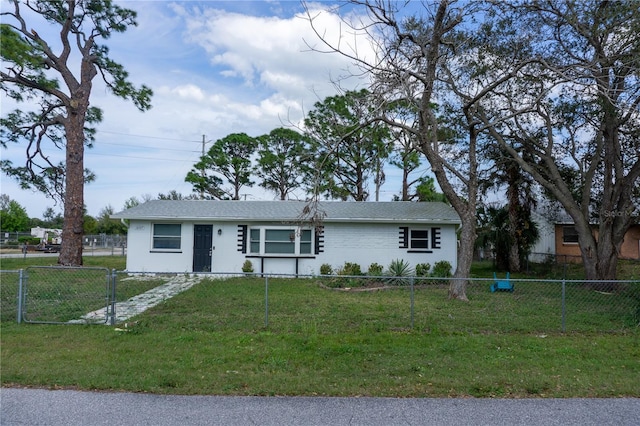 single story home featuring a front yard, fence private yard, and brick siding