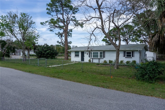 single story home with a fenced front yard and a front lawn