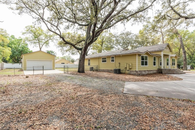 view of property exterior featuring an outbuilding, a garage, and fence