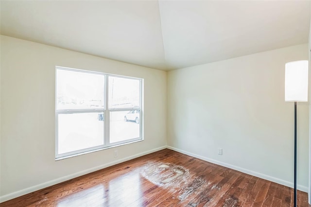 spare room with wood finished floors and baseboards