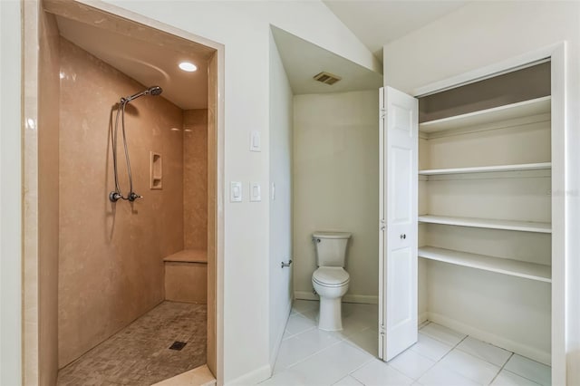 bathroom featuring visible vents, a shower stall, baseboards, toilet, and tile patterned floors