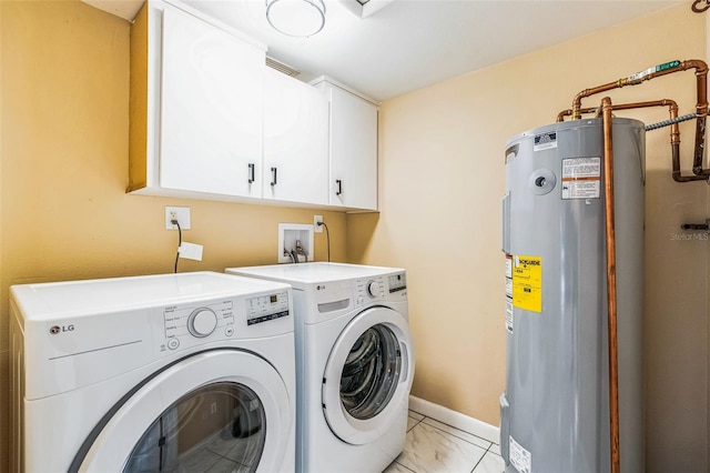 clothes washing area featuring electric water heater, baseboards, washing machine and dryer, cabinet space, and marble finish floor