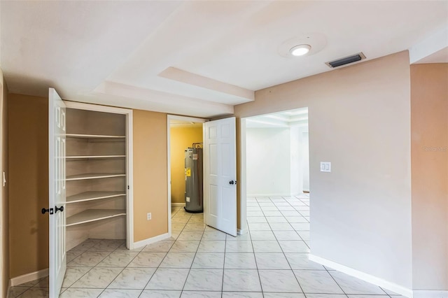 interior space featuring water heater and visible vents