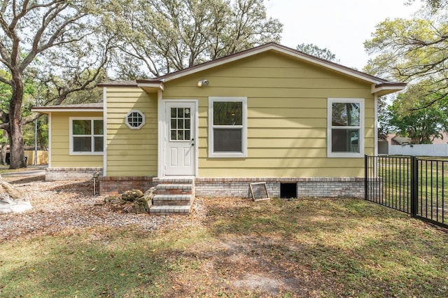 bungalow-style home featuring crawl space, fence, and entry steps