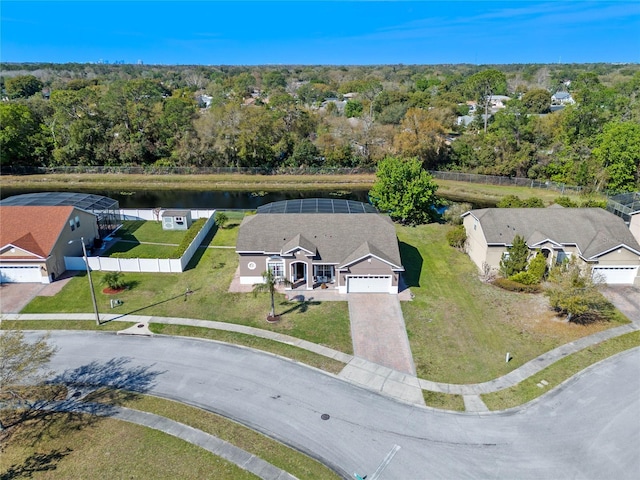 drone / aerial view featuring a water view and a wooded view