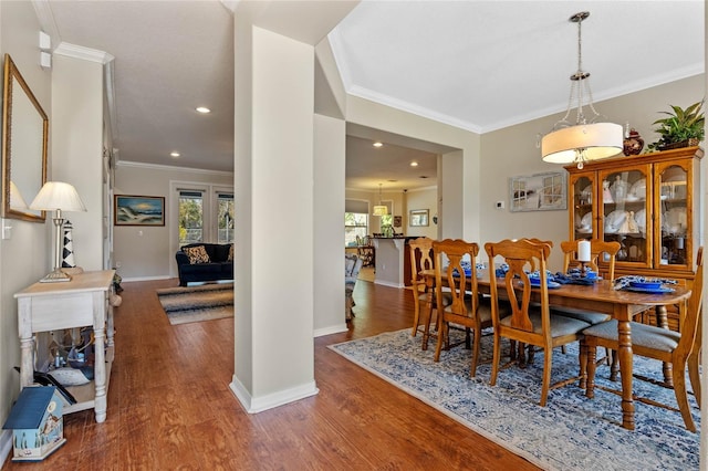 dining space with a healthy amount of sunlight, baseboards, and wood finished floors