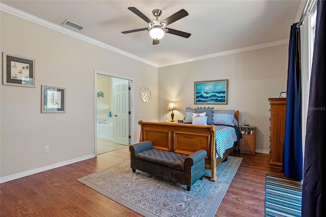 bedroom with crown molding, wood finished floors, visible vents, and baseboards