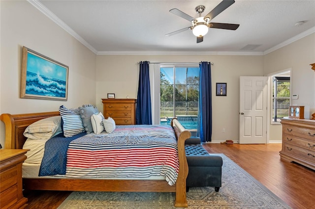 bedroom with a ceiling fan, wood finished floors, baseboards, ornamental molding, and access to outside