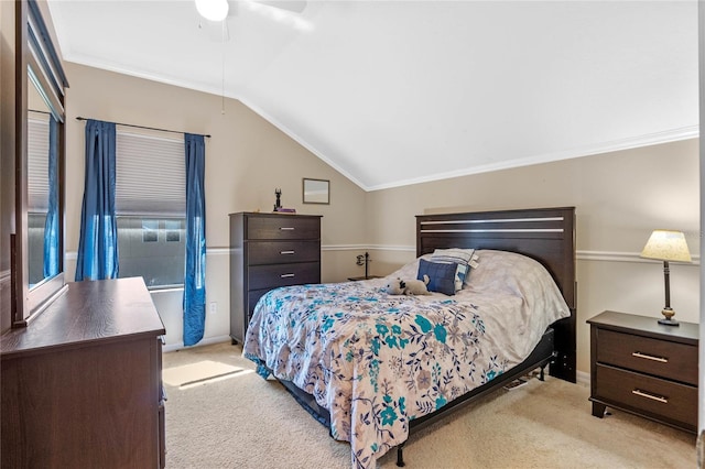 carpeted bedroom with baseboards, ceiling fan, crown molding, and vaulted ceiling