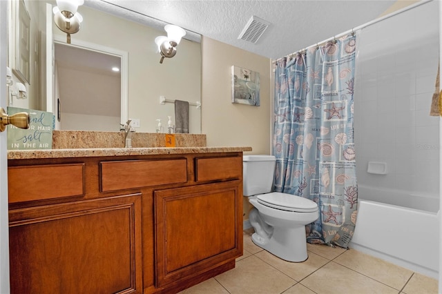 bathroom with tile patterned flooring, toilet, visible vents, and a textured ceiling