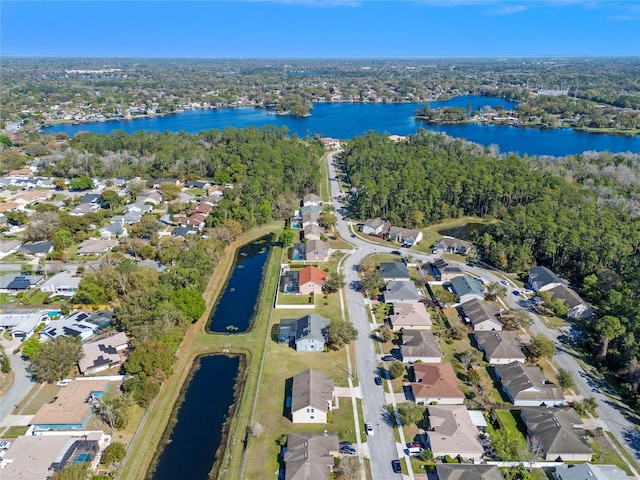 drone / aerial view with a residential view and a water view