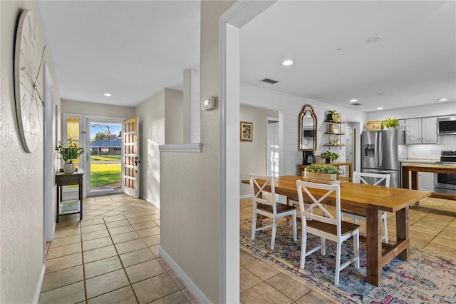 dining area with light tile patterned floors, visible vents, recessed lighting, and baseboards