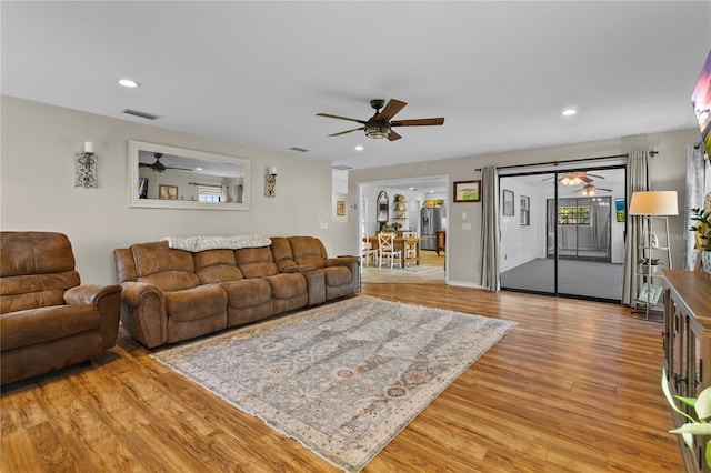 living area featuring visible vents, recessed lighting, a ceiling fan, and light wood-style floors