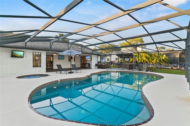 outdoor pool featuring a patio area, a lanai, and a hot tub