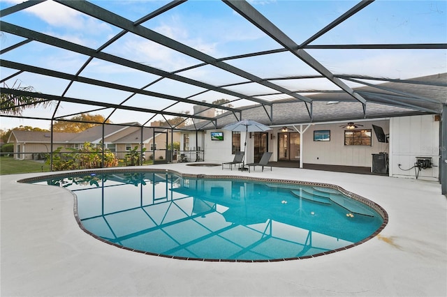 outdoor pool with a lanai and a patio area