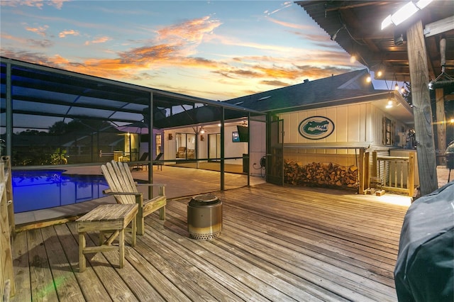 deck with glass enclosure and an outdoor pool