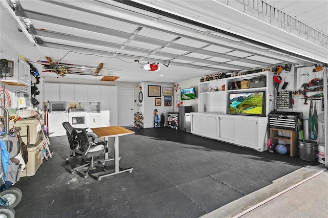 garage featuring independent washer and dryer, a garage door opener, and refrigerator