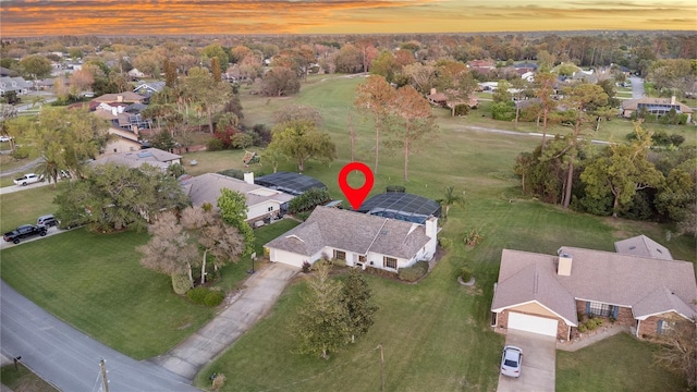 aerial view at dusk featuring a residential view