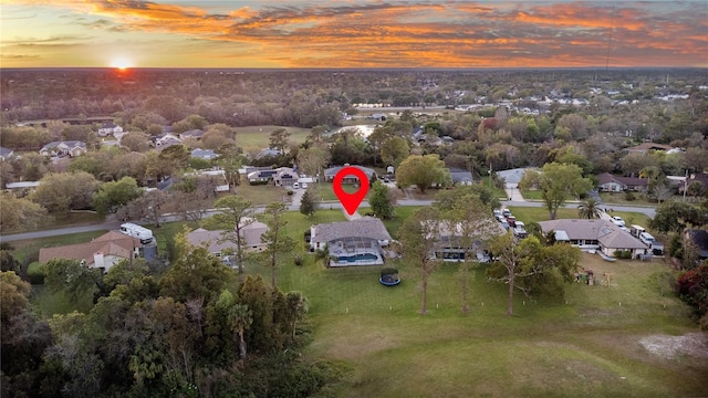 aerial view at dusk featuring a residential view