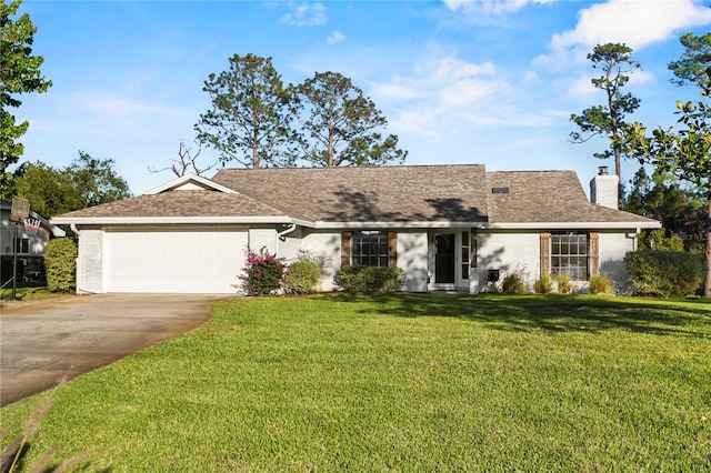 ranch-style house featuring brick siding, driveway, a chimney, and a front lawn