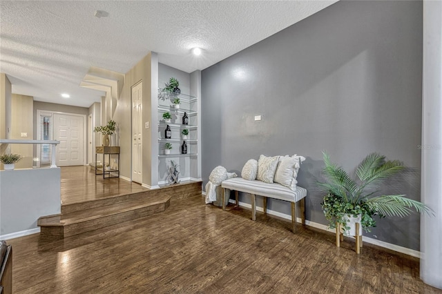 living area featuring baseboards and wood finished floors