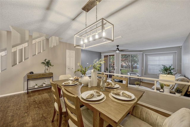 dining space featuring ceiling fan, wood finished floors, baseboards, and a textured ceiling