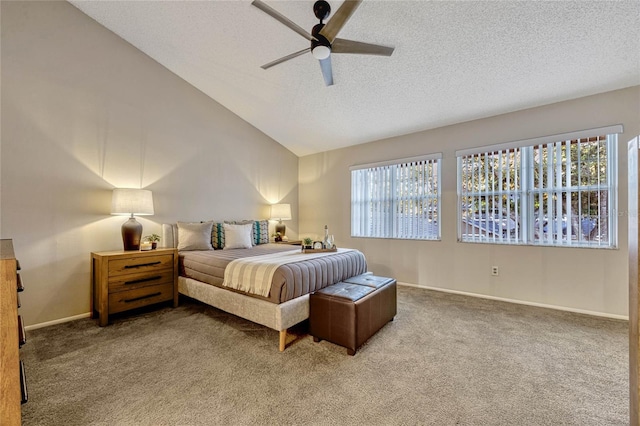 carpeted bedroom featuring baseboards, multiple windows, a textured ceiling, and lofted ceiling