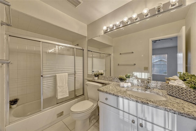 bathroom featuring tile patterned flooring, visible vents, bath / shower combo with glass door, toilet, and vanity