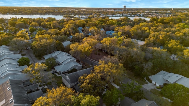 birds eye view of property with a residential view, a view of trees, and a water view