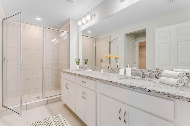 bathroom with recessed lighting, a stall shower, vanity, and tile patterned flooring