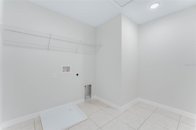 clothes washing area with hookup for a washing machine, baseboards, hookup for an electric dryer, laundry area, and light tile patterned flooring