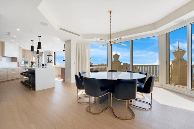 dining area featuring recessed lighting, visible vents, an inviting chandelier, and light wood-style flooring