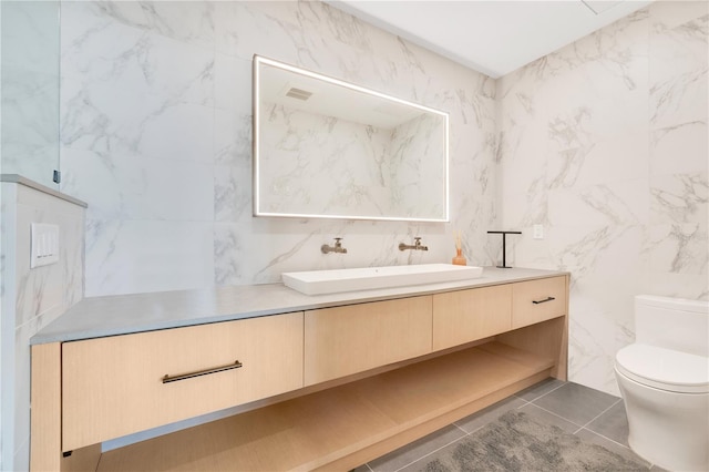 bathroom with vanity, tile patterned floors, and toilet