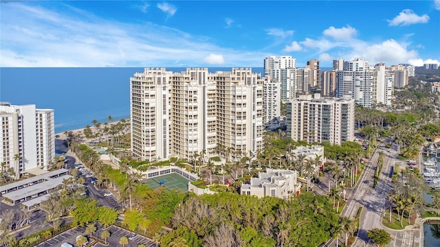 birds eye view of property featuring a water view and a city view