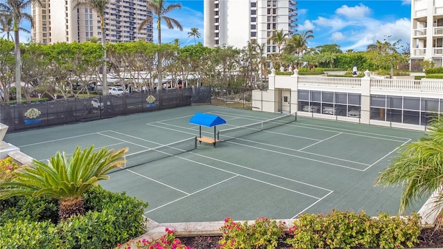 view of sport court featuring fence