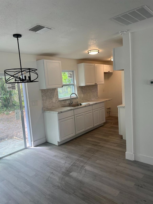 kitchen with visible vents, light countertops, and a sink