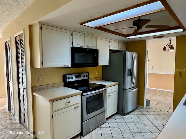 kitchen with light tile patterned floors, a ceiling fan, visible vents, light countertops, and appliances with stainless steel finishes