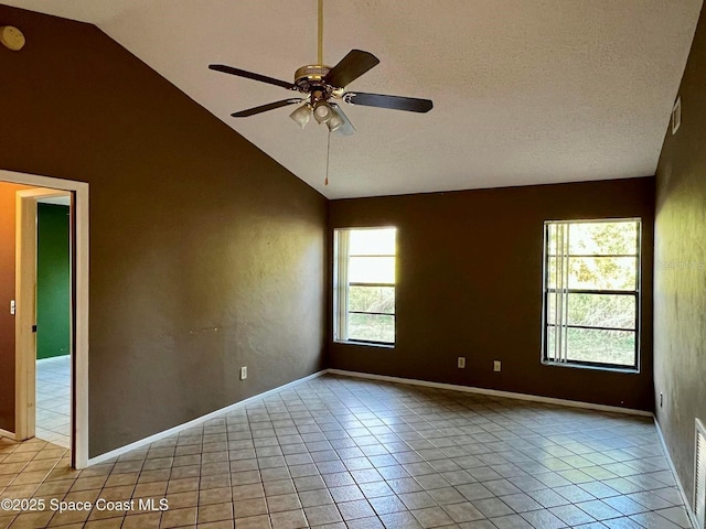 unfurnished room with visible vents, high vaulted ceiling, a ceiling fan, a textured ceiling, and light tile patterned floors