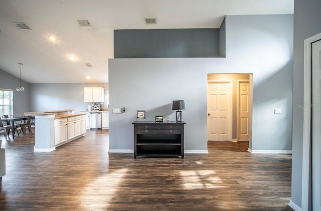 interior space with dishwasher, white cabinetry, visible vents, and dark wood-style flooring