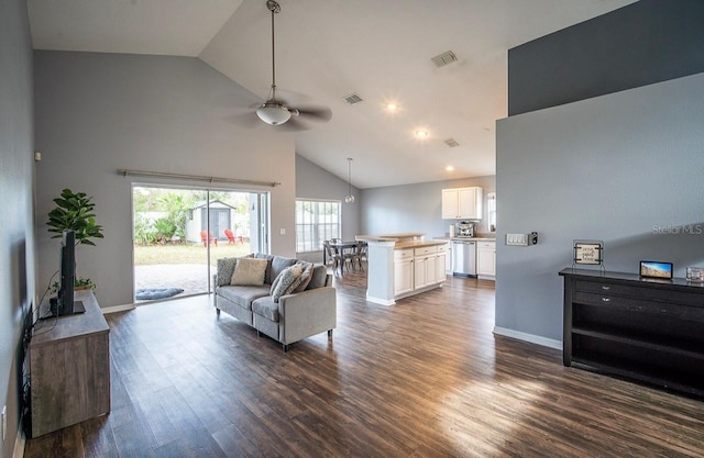 living area featuring visible vents, high vaulted ceiling, a ceiling fan, dark wood finished floors, and baseboards