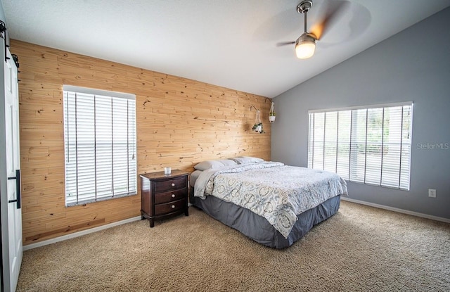 bedroom with wooden walls, vaulted ceiling, and carpet