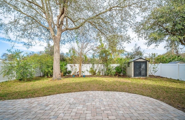 view of patio / terrace featuring an outbuilding, a fenced backyard, and a shed