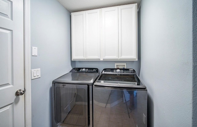 laundry room featuring washer and clothes dryer and cabinet space