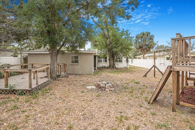 fenced backyard with a deck
