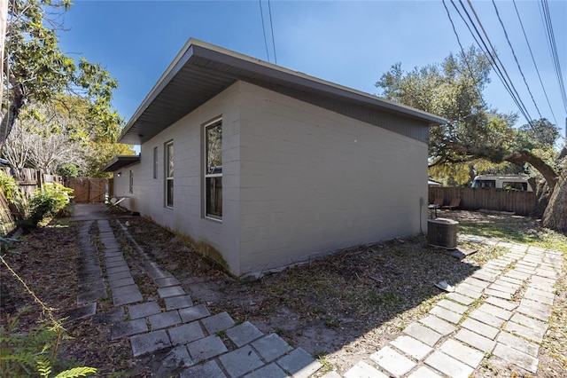 view of home's exterior with central air condition unit and a fenced backyard