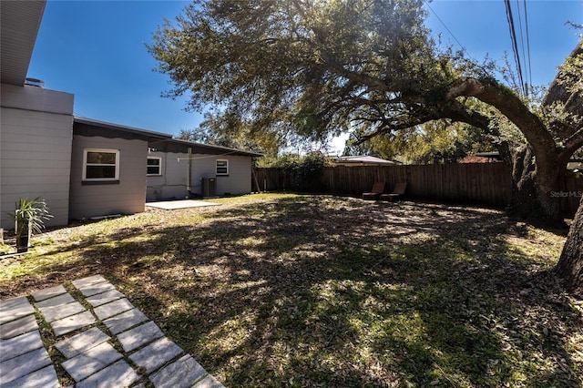 view of yard featuring a patio, cooling unit, and a fenced backyard