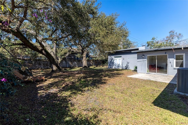 view of yard featuring a patio, central AC unit, and fence