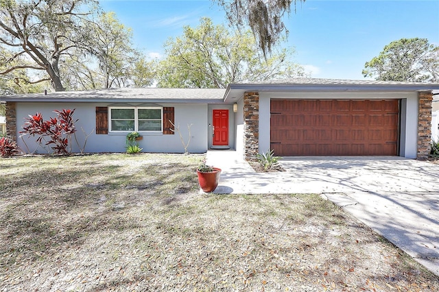 view of front of property featuring stucco siding, stone siding, concrete driveway, and an attached garage