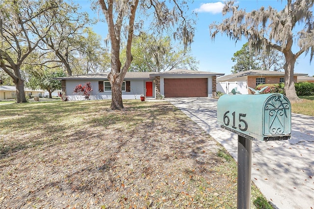 single story home featuring an attached garage and driveway